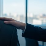 Mano sobre el hombro de un colega en oficina moderna