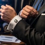 Manos ajustando un traje moderno con gemelo LinkedIn